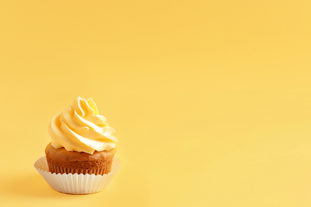 Tasty cupcake on color backgroundの写真素材