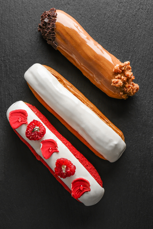 Various tasty eclairs on dark backgroundの写真素材