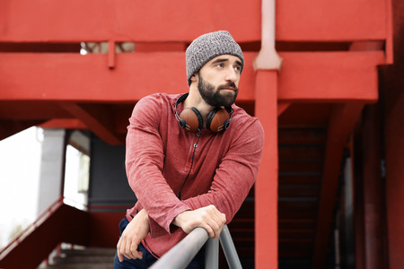 Portrait of young hipster man with headphones outdoorsの写真素材