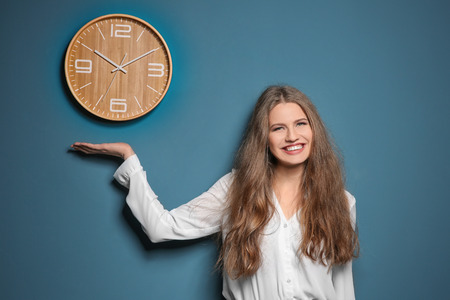 Beautiful manager near wall with clock
