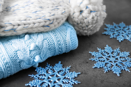 Warm knitted clothes on table. Seasonal female wardrobeの写真素材