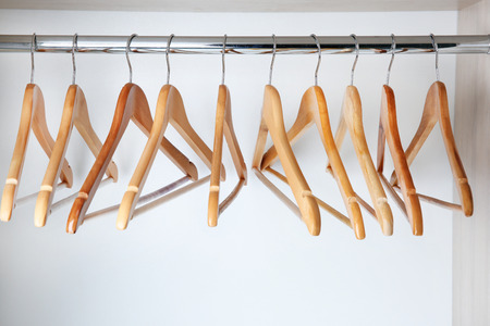 Clothes hangers in empty wardrobeの写真素材