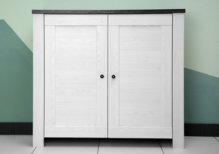 Beautiful wardrobe on floor against color wallの写真素材