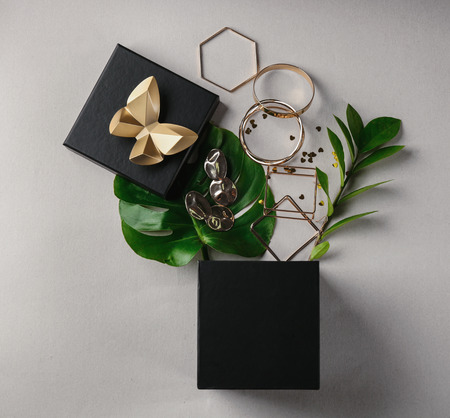 Opened gift box and golden accessories on light background, top viewの写真素材