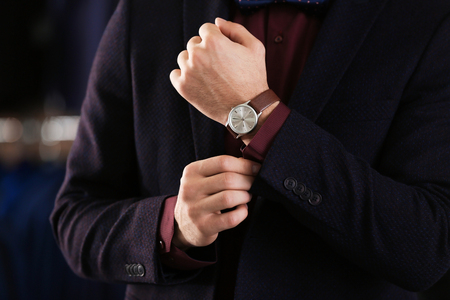 Young man in elegant suit on blurred backgroundの写真素材