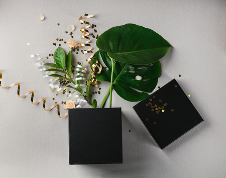 Opened gift box, leaves and decor on light background, top viewの写真素材