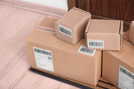Parcel boxes on floor near doorの写真素材