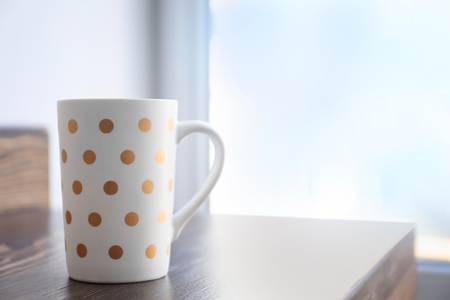 Cup of coffee on window sillの写真素材