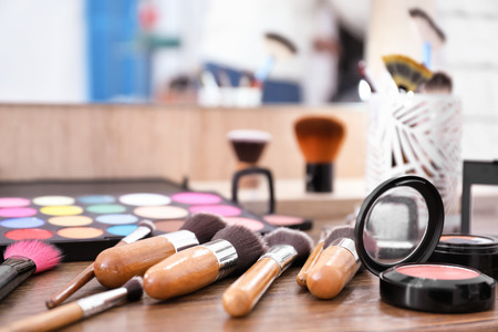 Decorative cosmetics and tools of professional makeup artist on dressing tableの写真素材