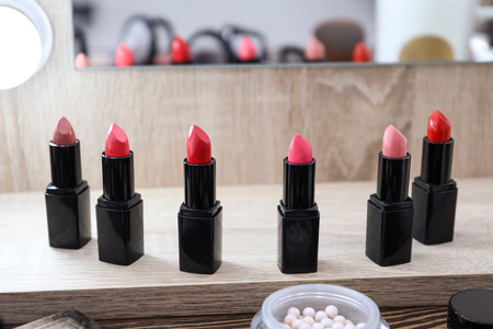 Colorful lipsticks of professional makeup artist on dressing tableの写真素材