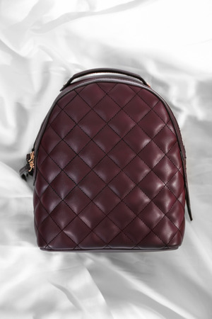 Top view of stylish backpack on fabric backgroundの写真素材