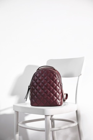 Stylish backpack on white chairの写真素材