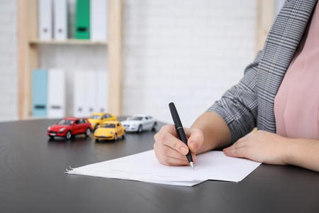 Auto insurance agent at workplace, closeup
