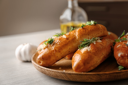 Plate with delicious homemade garlic bread on tableの写真素材