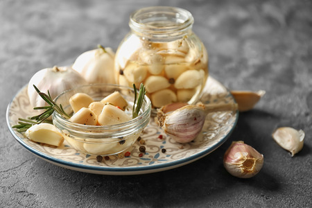 Preserved garlic in glassware on plateの写真素材
