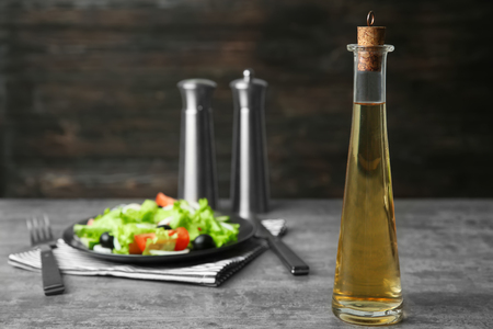 Bottle with tasty apple vinegar on tableの写真素材