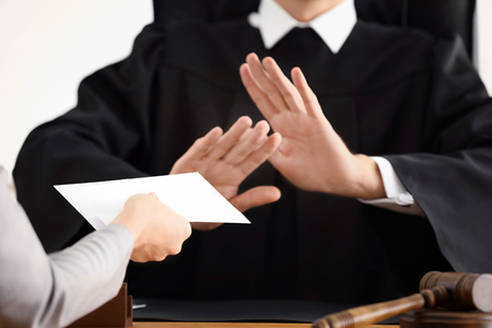 Male judge refusing to take bribe from woman, closeupの写真素材