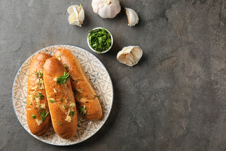 Plate with delicious homemade garlic bread on tableの写真素材