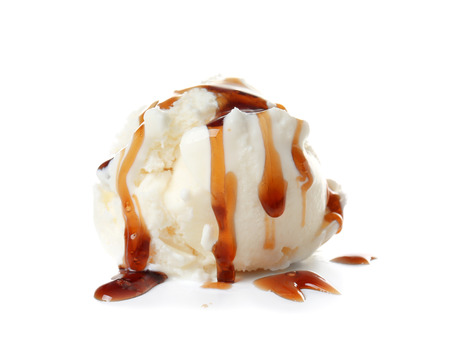 Ice cream ball with caramel sauce on white backgroundの写真素材