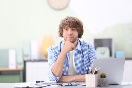 Portrait of stylish young man in officeの写真素材