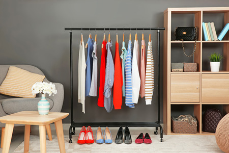 Rack with collection of clothes in dressing roomの写真素材
