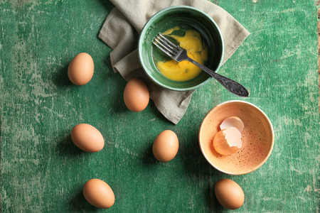 Composition with chicken eggs on wooden table