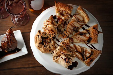 Tasty pear tart with chocolate sauce on cake stand, top viewの写真素材