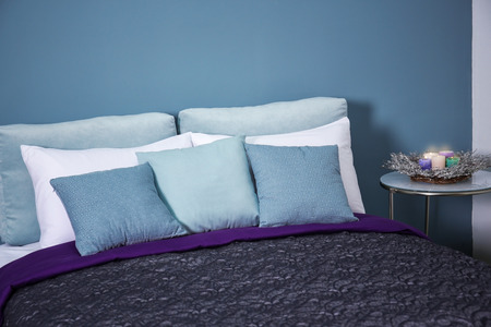 Comfortable bed with soft pillows indoors