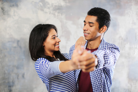 Attractive African-American couple dancing at homeの写真素材