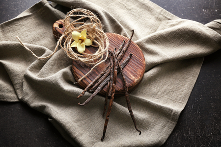 Composition with vanilla sticks and flower on table