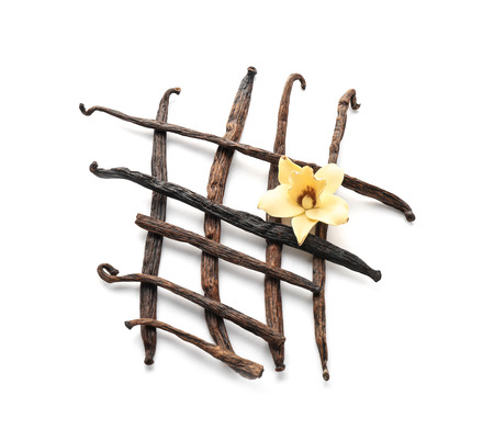 Vanilla sticks and flower on white background