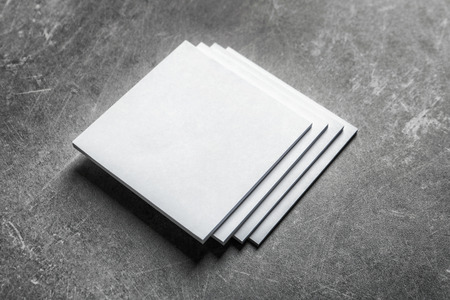 Blank sheets of paper on grey background. Mock up for designの写真素材