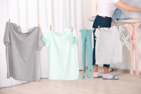 Clothes hanging on laundry line indoorsの写真素材