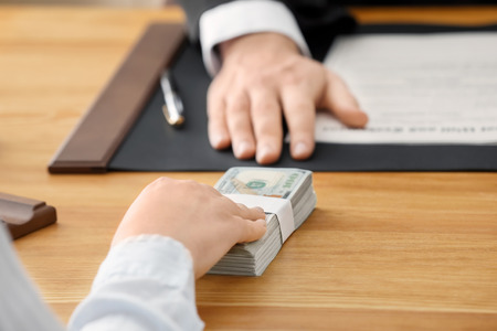 Woman offering bribe to businessman, closeup