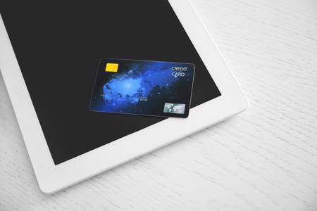 Tablet computer and credit card on table, closeup. Internet shopping conceptの写真素材