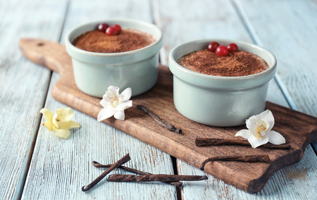 Composition with tasty vanilla pudding on wooden backgroundの写真素材