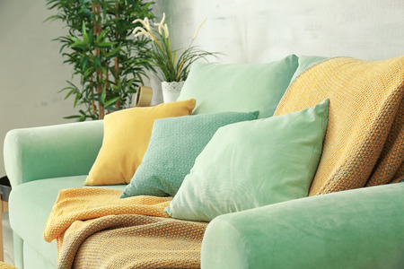 Comfortable mint couch with cushions in living room