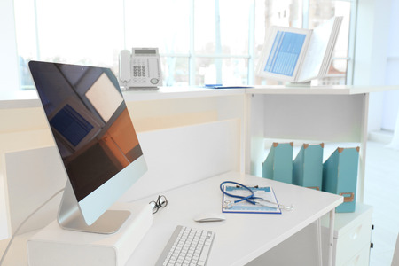 Computer on reception desk in modern hospitalの写真素材