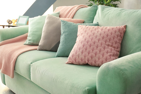 Comfortable mint couch with cushions in living roomの写真素材