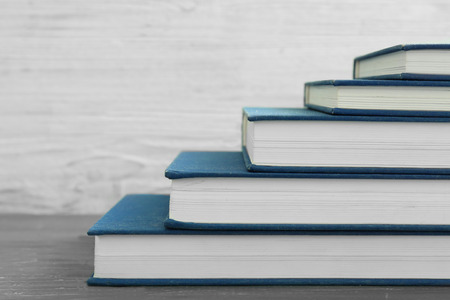 Stack of books on table, closeup. Study goals