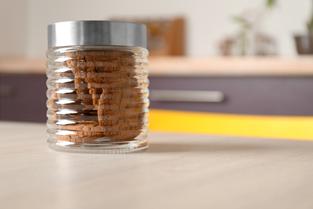 Delicious oatmeal cookies in glass jar on tableの写真素材