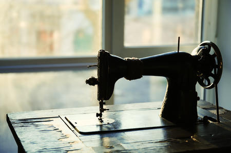 Vintage sewing machine in tailor's workshop