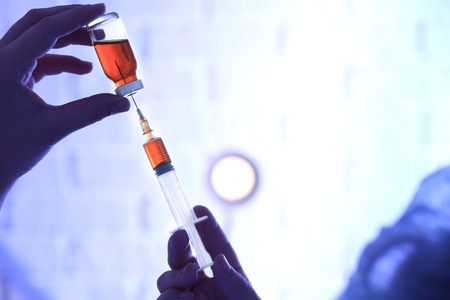 Doctor holding syringe and medicine for vaccination, closeupの写真素材
