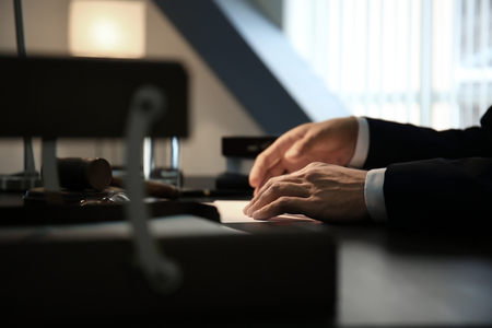 Male lawyer working late in office, closeupの写真素材