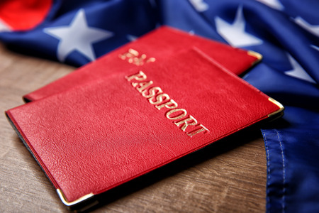 Passports and USA flag on table. American visa concept