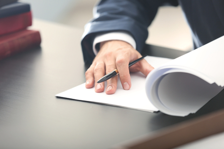 Male lawyer working in office, closeupの写真素材