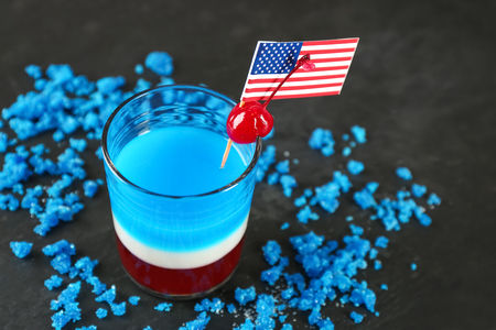 Layered cocktail in colors of American flag on tableの写真素材