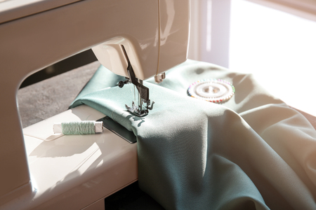 Modern sewing machine with fabric and thread, closeupの写真素材