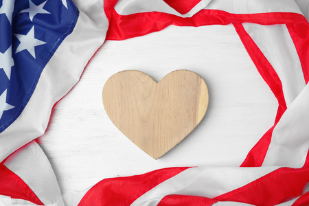 Wooden heart and American flag on light background. USA holidayの写真素材