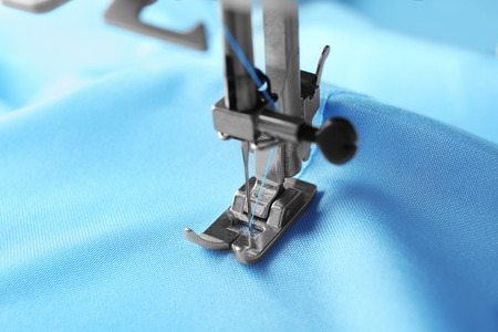 Sewing machine with fabric and thread, closeup